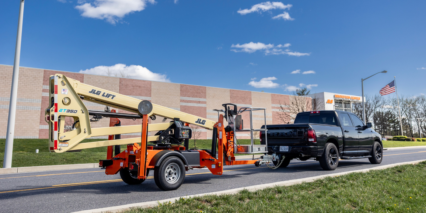 JLG Towable Boom Lift being towed by a truck
